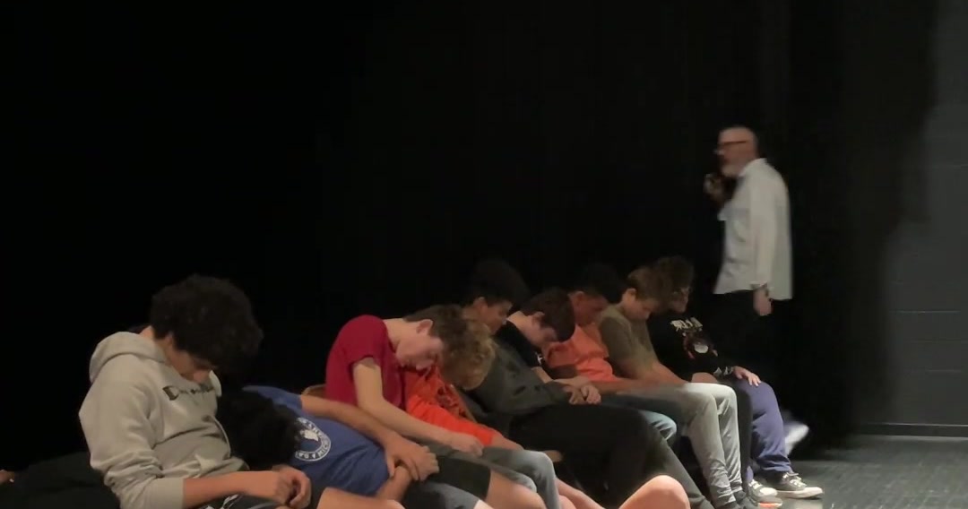 Hypnotized volunteers asleep on stage during a Dennis Timlick comedy hypnosis show